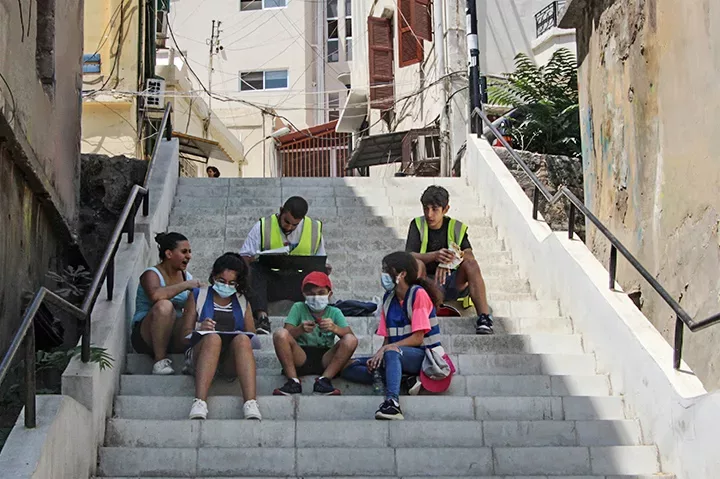 Group of amateur architects and urban planners sitting on stairs