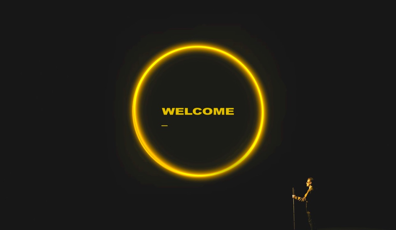 Welcome in yellow circle on screen behind XAmbassadors