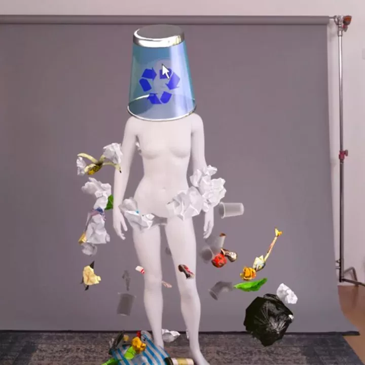 mannequin with trash can over the head and trash floating around