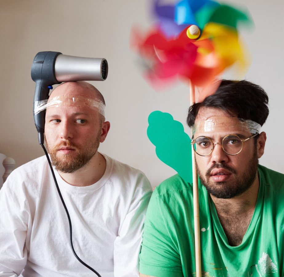 Rottingdean Bazaar with hairdryer and pinwheel tapped to their heads