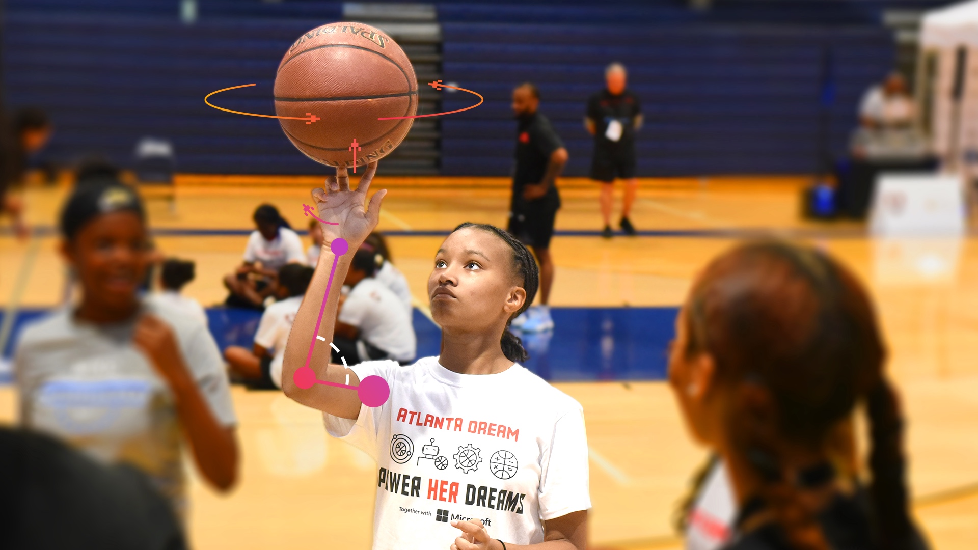 A girl is holding a basketball in front of a group of people.