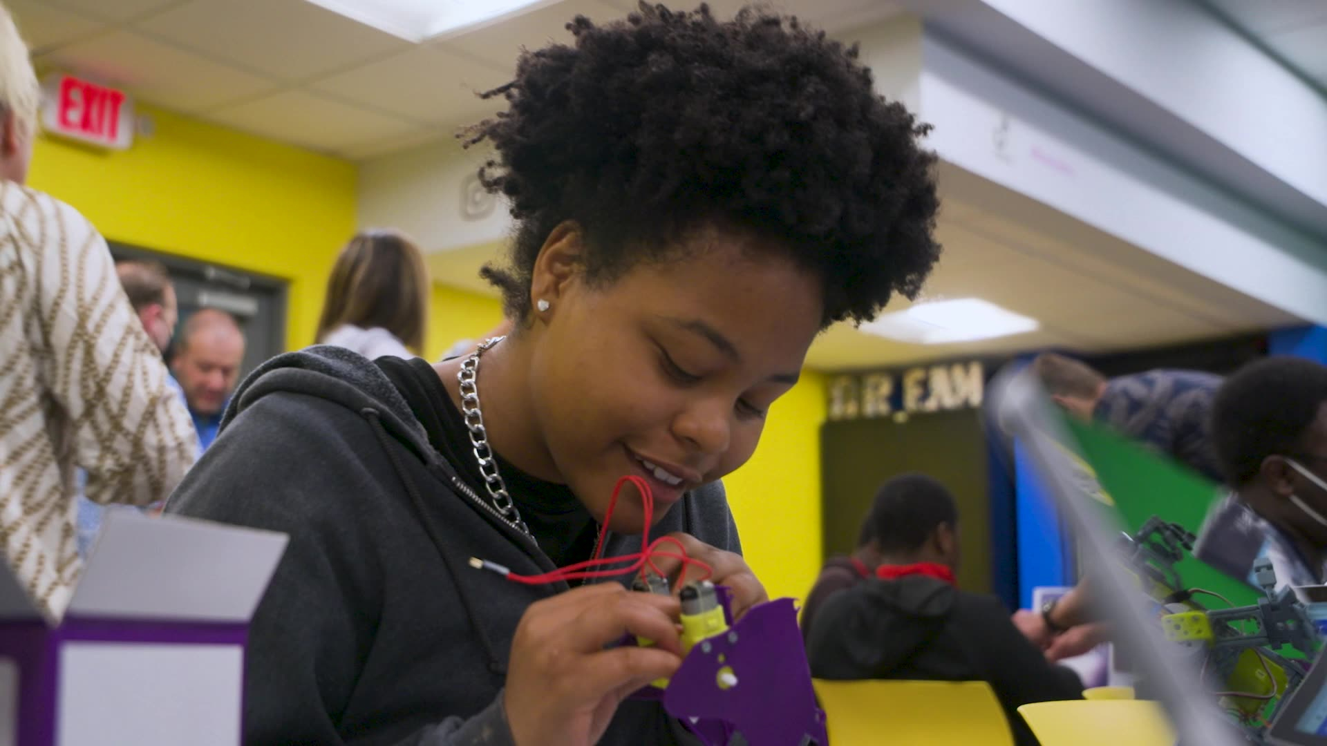 A girl is working on a laptop in a classroom.