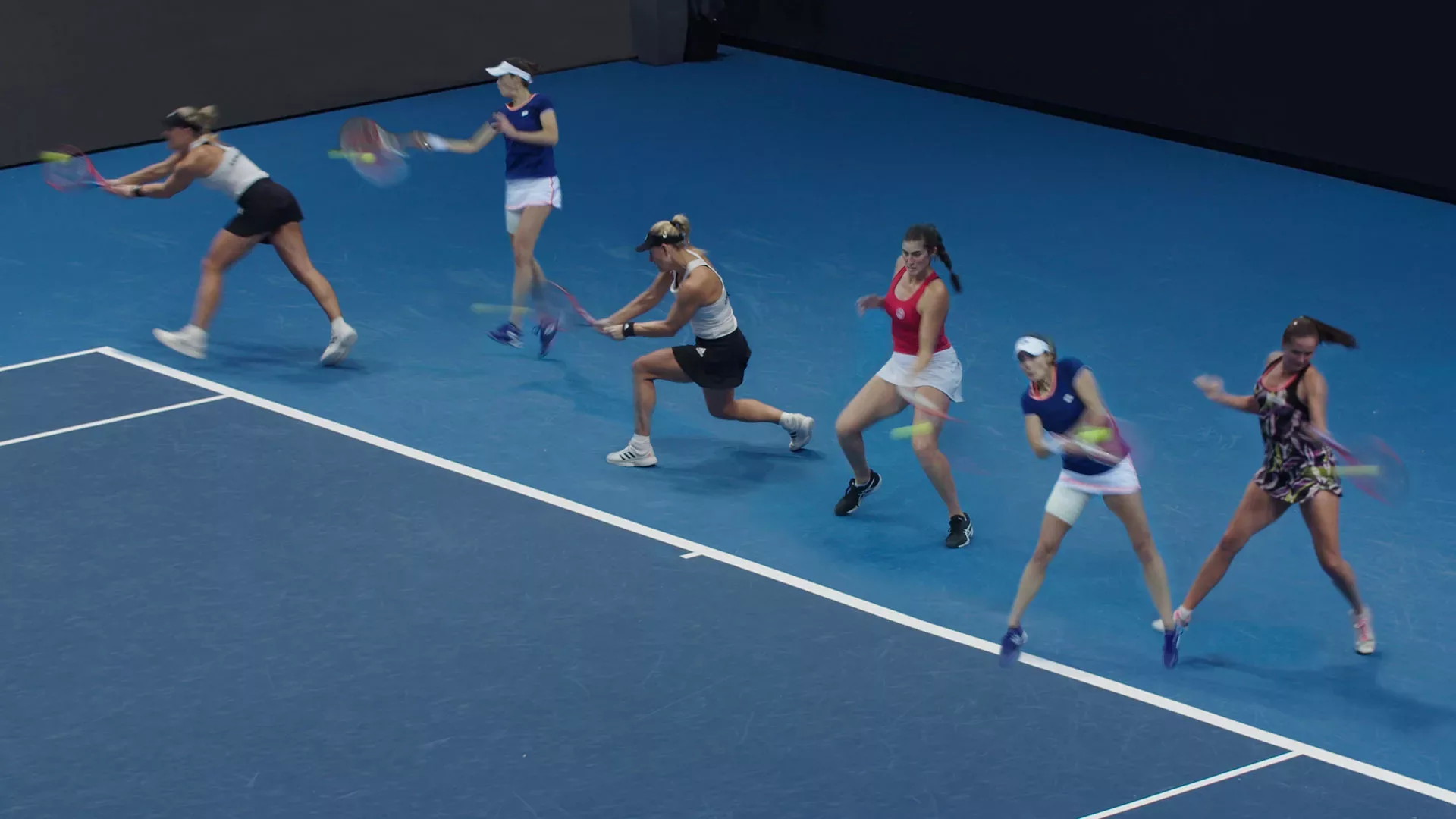 Six tennis players are lined up on a court practicing their swings.