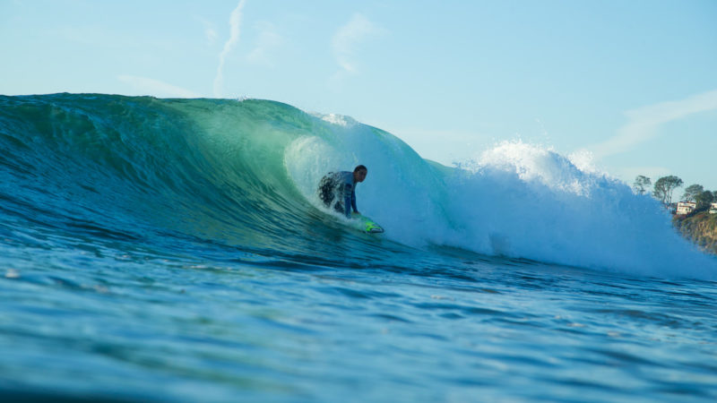 Surfer riding barreling wave