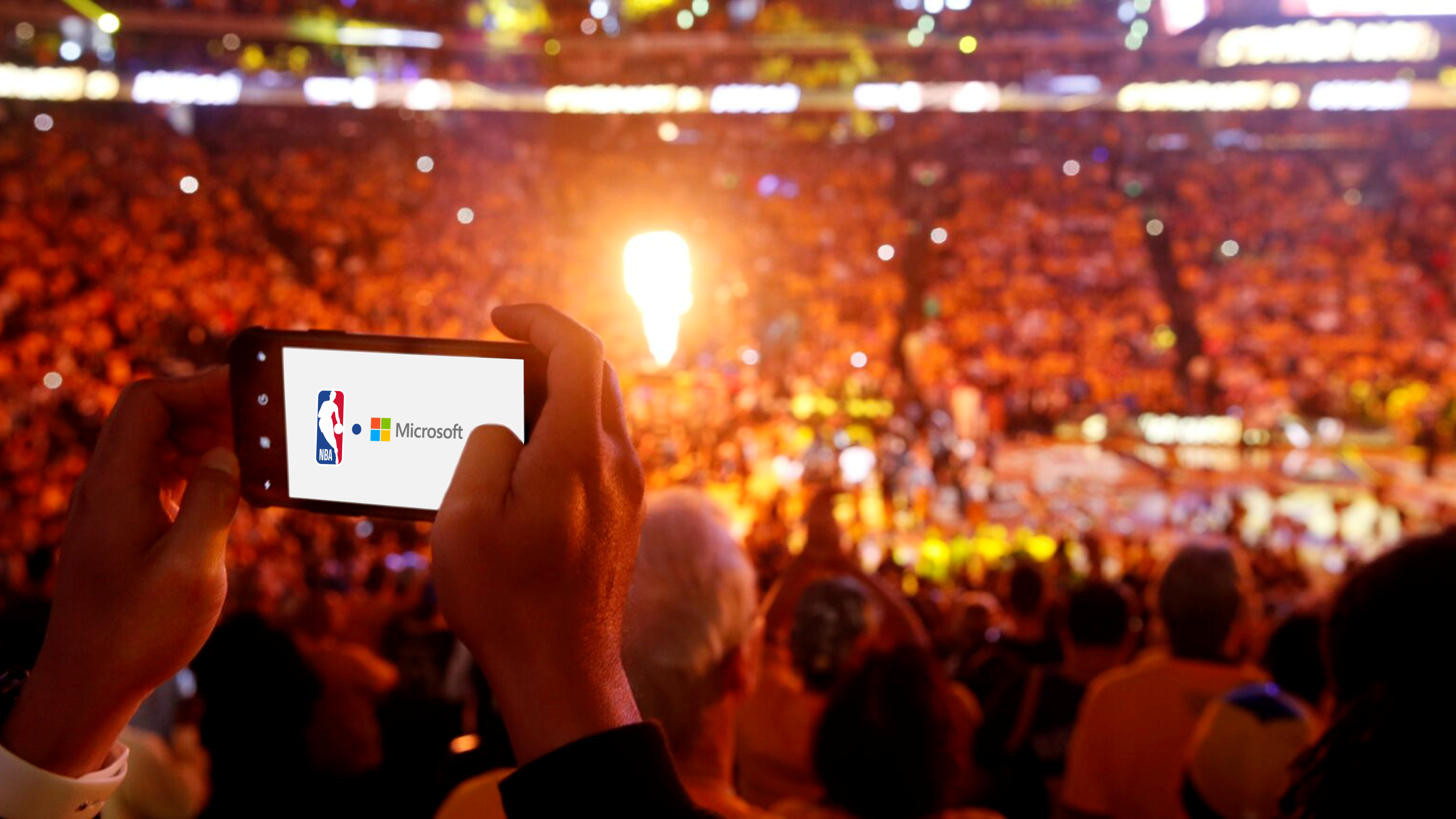 A fan uses his iPhone to take a photo of player introductions prior to Game Four of the 2019 NBA Finals between the Golden State Warriors and the Toronto Raptors at ORACLE Arena on June 07, 2019 in Oakland, California.