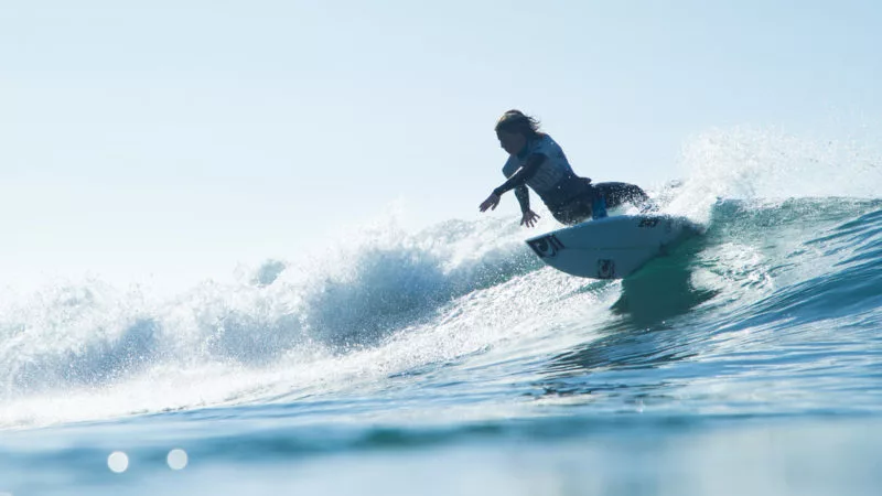 Surfer riding wave on short board