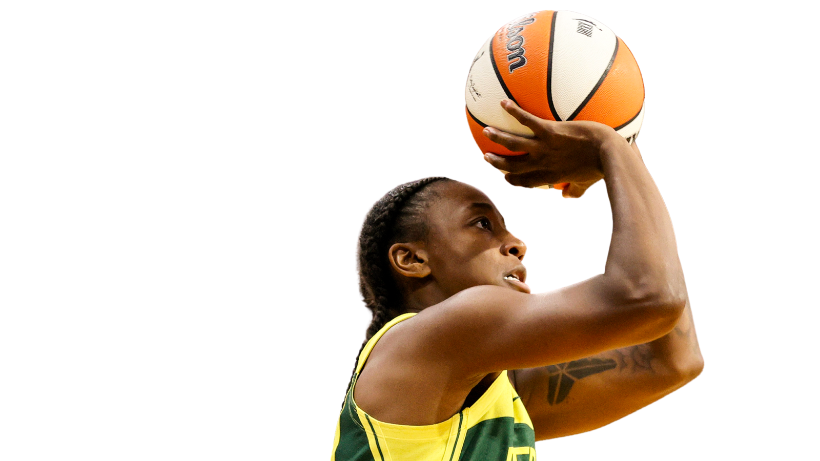 WNBA basketball player, Jewell Loyd is mid-jump with a basketball in her hands. She is portrayed in front of a white background.