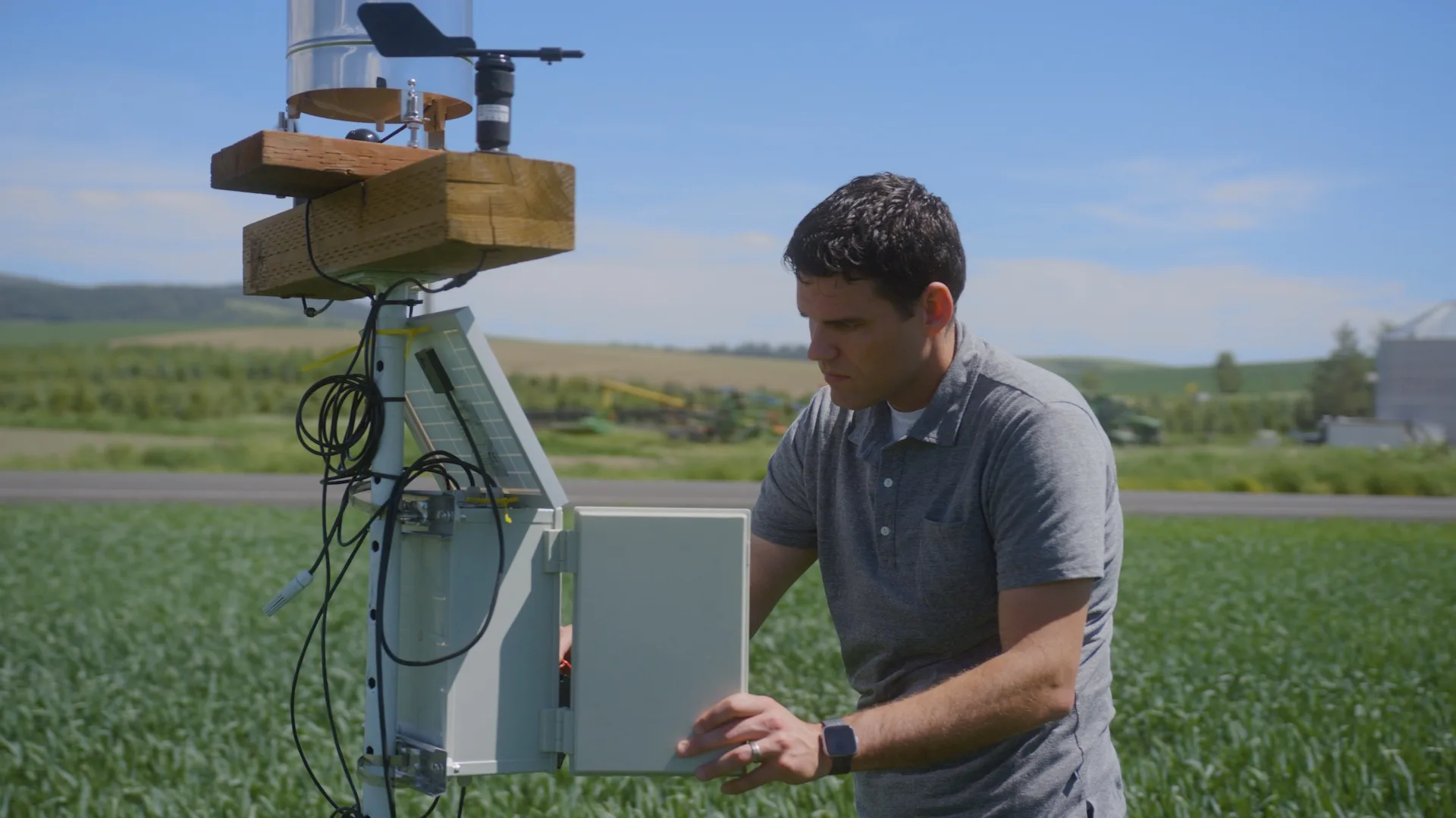 an image of a man on a farm interacting with AI-enabled technology.