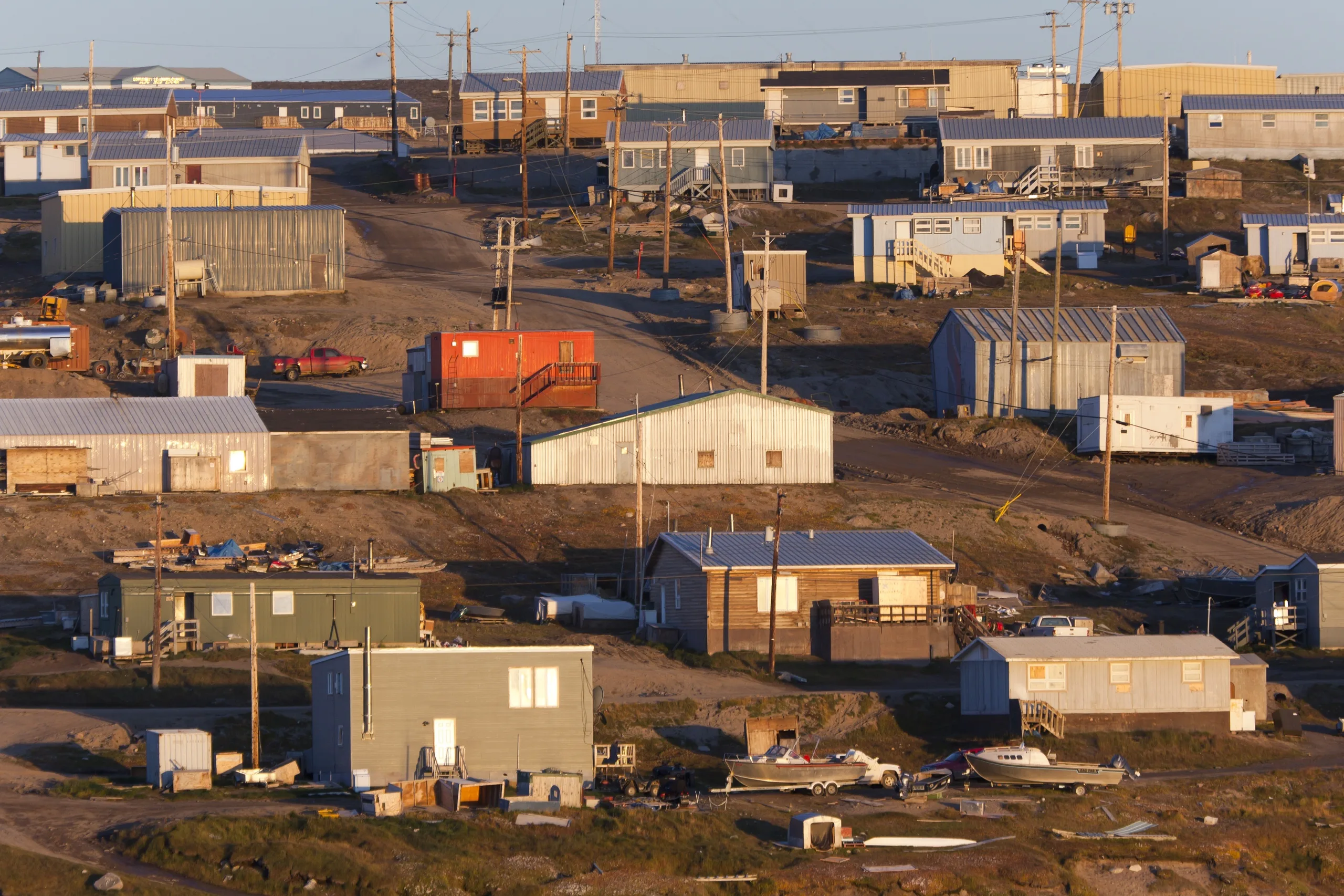 An aerial view of Nunavut, Canada with many houses and industrial buildings in view.