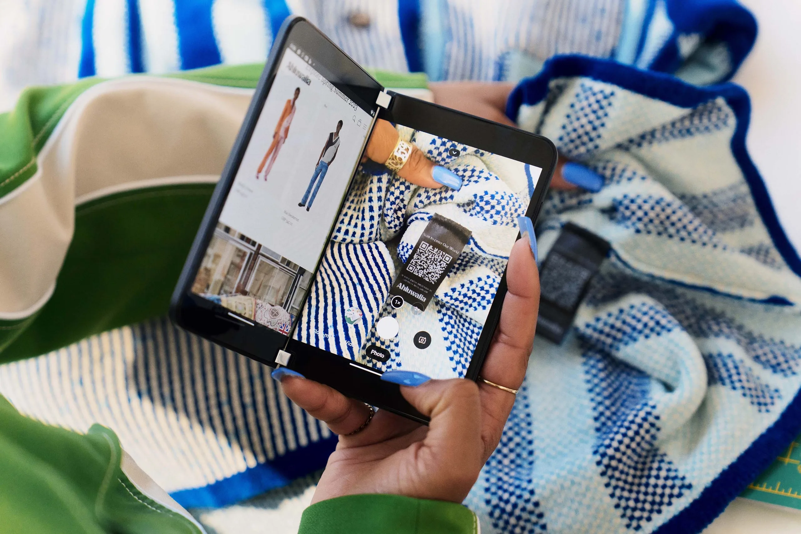 A person holding a tablet with a photo of a cloth.