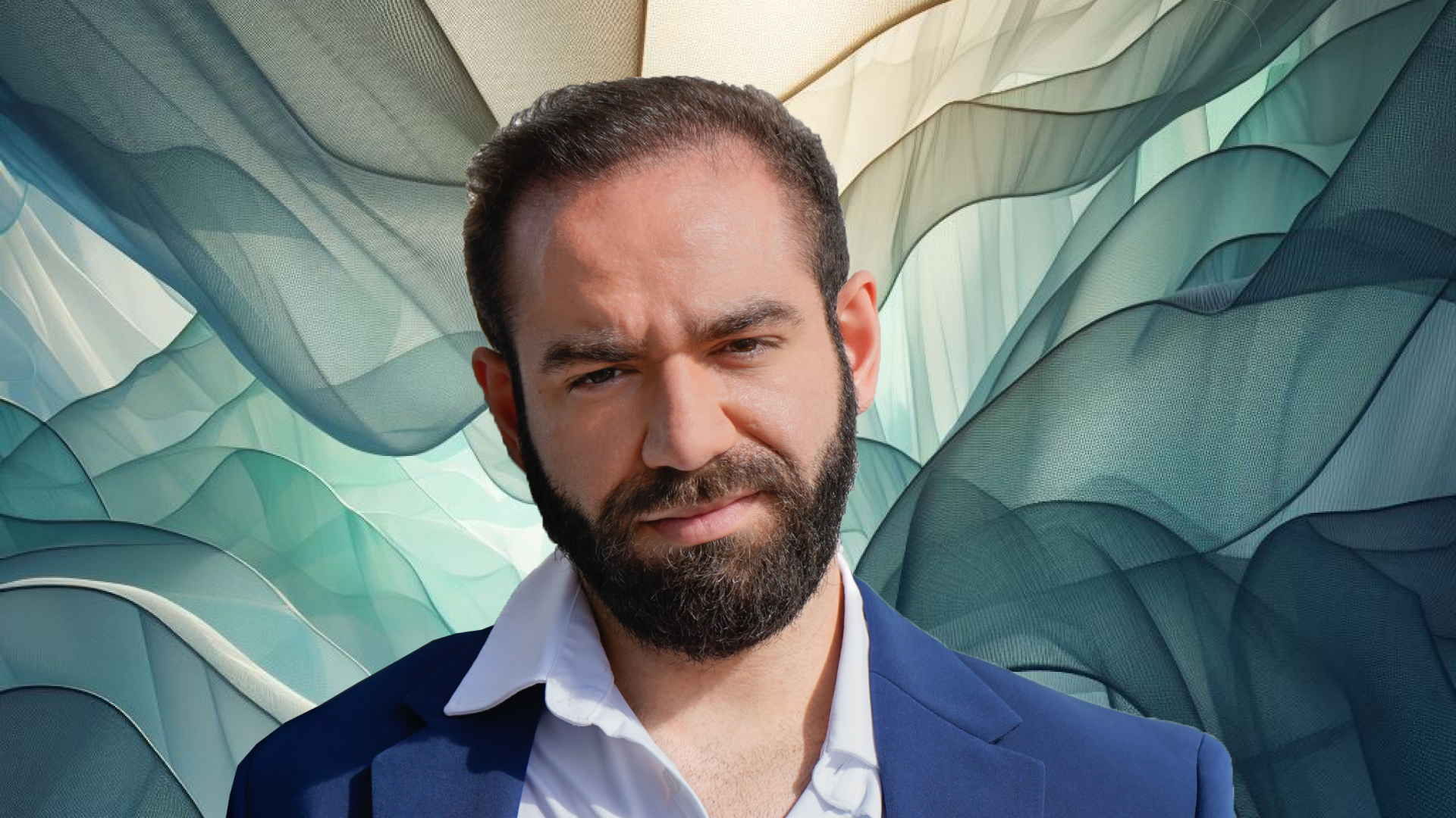 A man with a beard in front of a blue background.