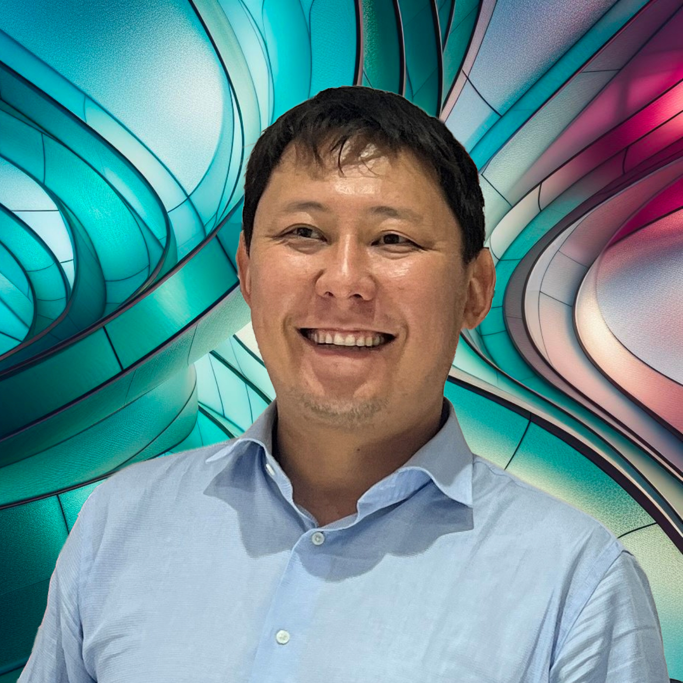 A man smiling in front of a colorful abstract background.