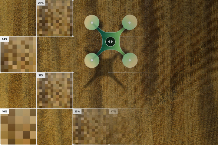 A top-down view of a green and white drone on a wooden surface, surrounded by pixelated squares with percentage labels.