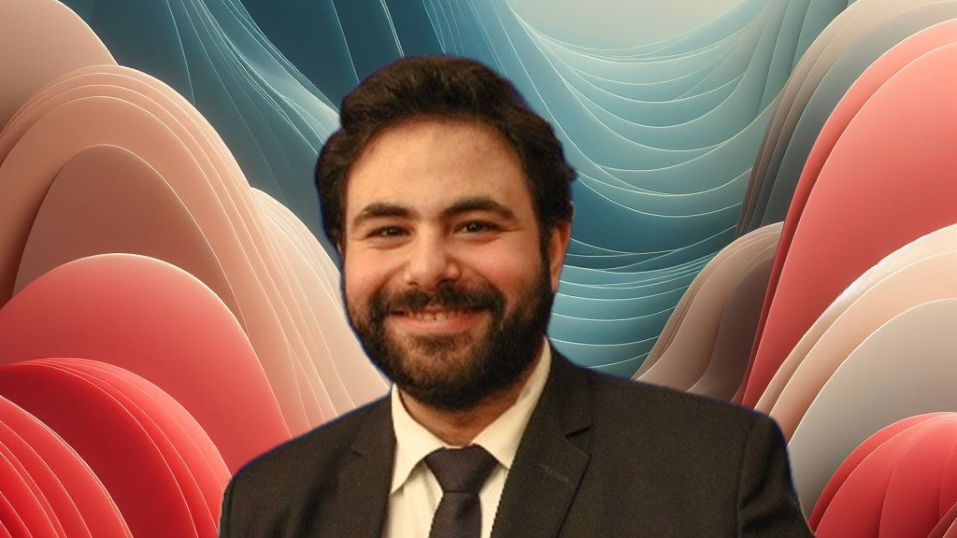 Man in a suit smiling, with stylized red and blue wavy background.