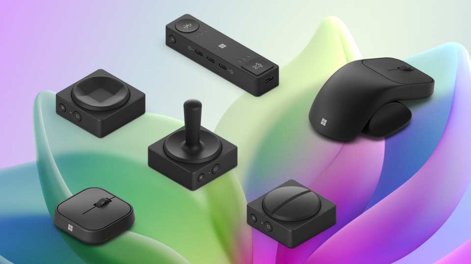 Various modern electronic peripherals, including a joystick, mouse, and different controllers, displayed on a colorful, abstract wavy background.