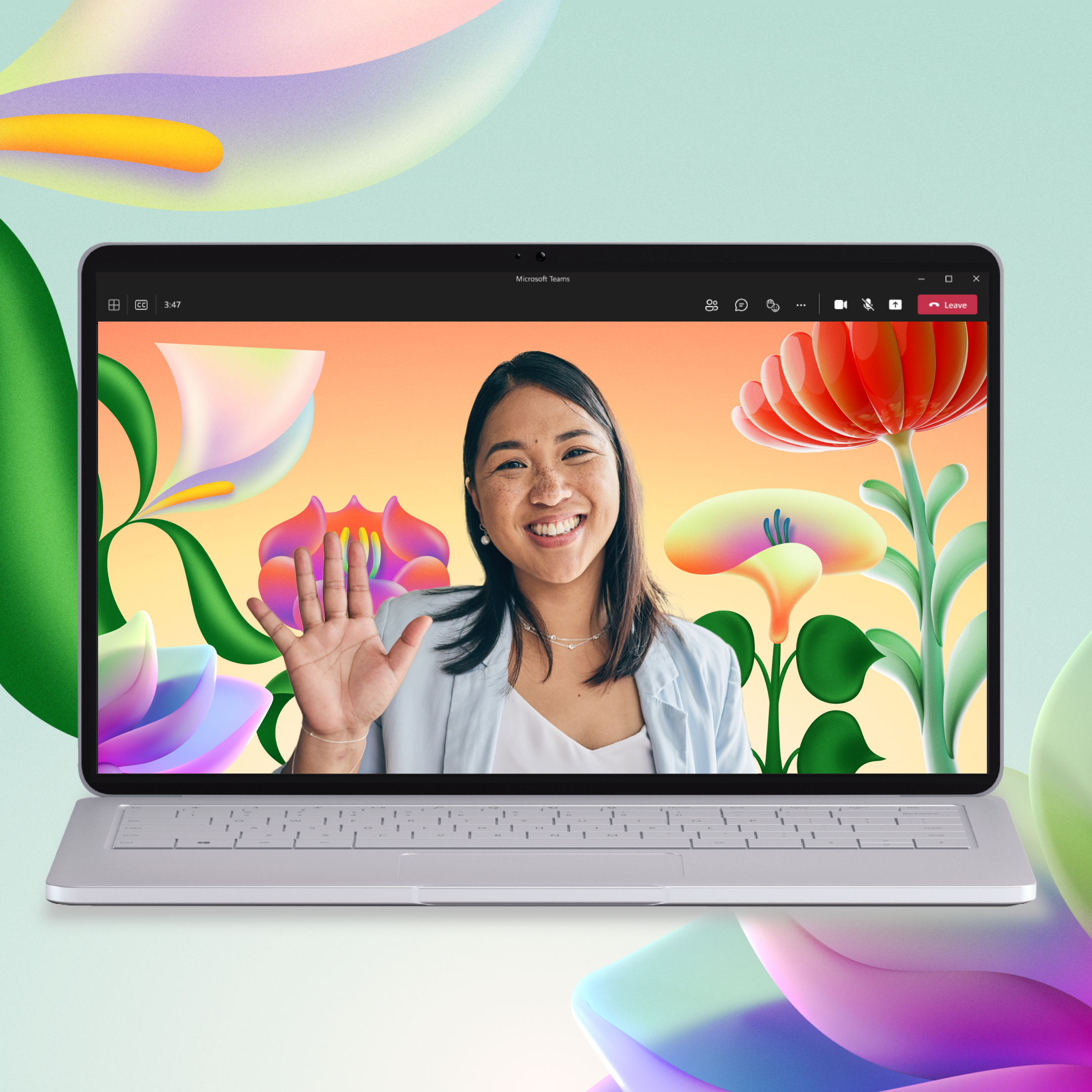 A woman smiles and waves from a laptop screen with a colorful floral background.