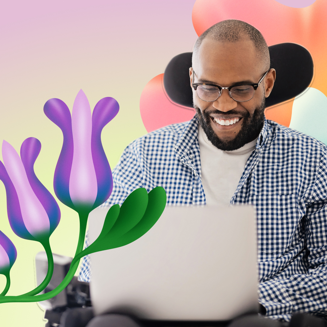 A joyful man wearing glasses and a plaid shirt using a laptop, with colorful abstract shapes and vibrant flowers in the background.