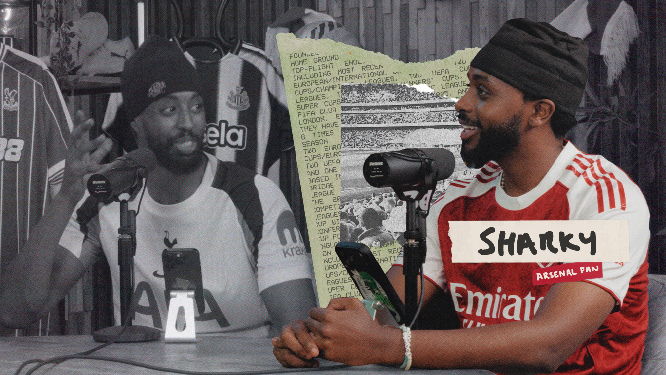 Two men sit at a table with microphones, podcast-style. One wears a Tottenham jersey, the other an Arsenal jersey labeled Sharky, Arsenal fan. The background includes football shirts and a sign of European tournament winners.