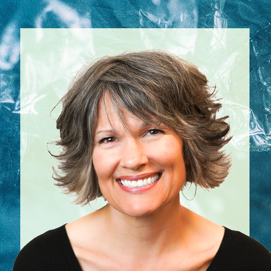A middle-aged woman with short, layered gray-brown hair smiles warmly at the camera, wearing a black top against a teal and light green textured background.