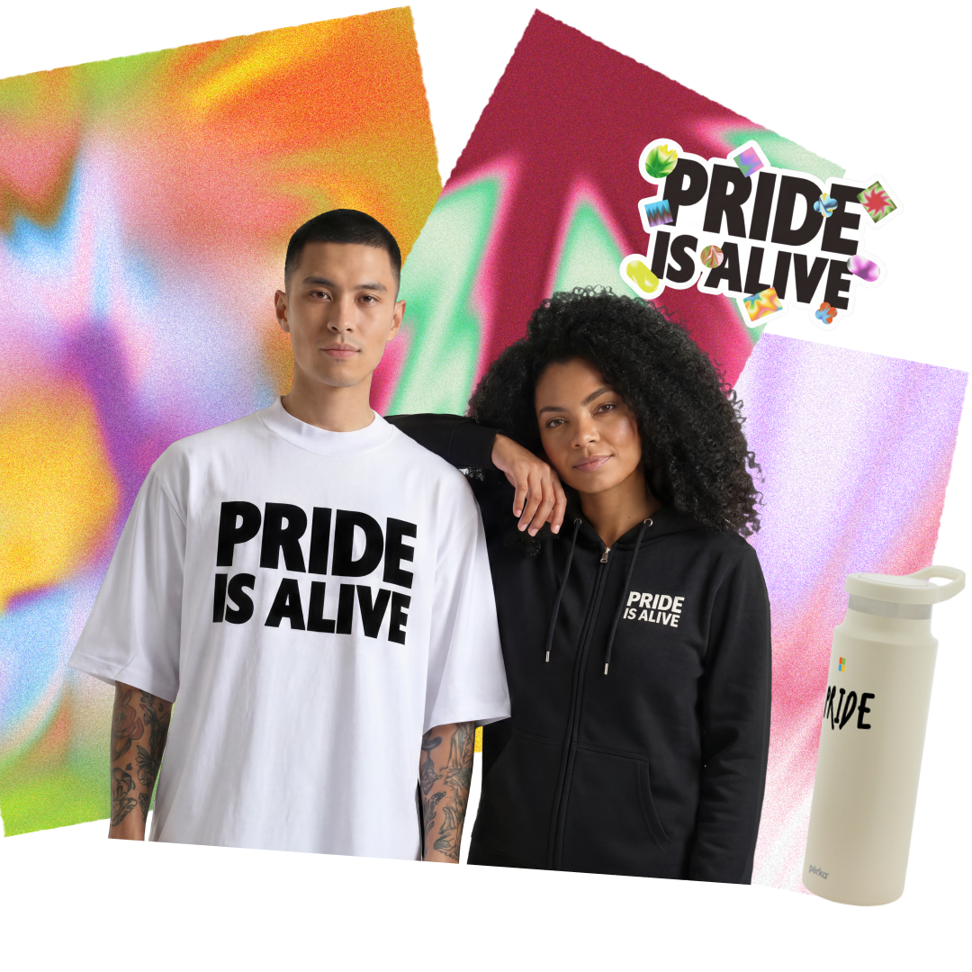 Two models wearing "Pride Is Alive" merchandise — a white oversized t-shirt and a black zip-up hoodie — posed against a colorful abstract background, alongside a